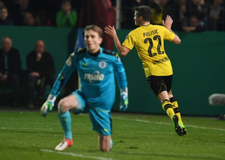 Dortmund's midfielder Christian Pulisic (R) celebrates scoring the opening goal during the German Cup DFB Pokal quarter-final football match Sportfreunde Lotte v BVB Borussia Dortmund, in Osnabruck, northern Germany on March 14, 2017