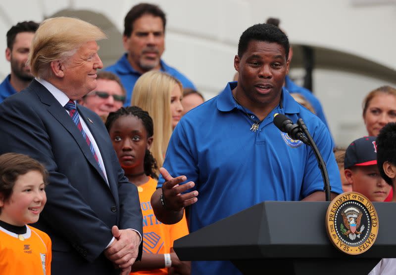 FILE PHOTO: President Trump listens to Herschel Walker during White House Sports and Fitness Day in Washington