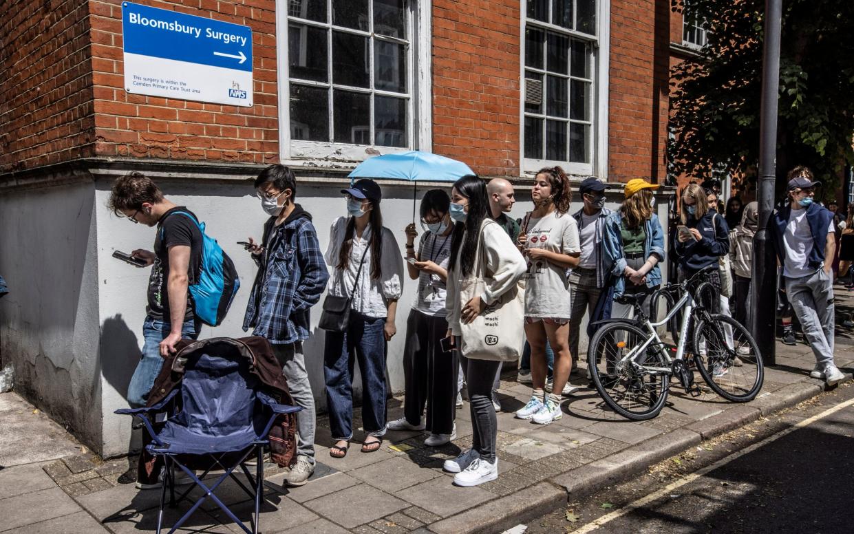 Students queue for coronavirus vaccinations at Bloomsbury Surgery in London - Jeff Gilbert 