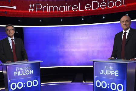 French politicians Alain Juppe (R) and Francois Fillon attend the third prime-time televised debate as they campaign in the second round for the French center-right presidential primary election in Paris, France, November 24, 2016. REUTERS/Eric Feferberg/Pool