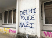 In this Wednesday, Dec. 18, 2019 photo, graffiti cover the wall of a building at Jamia Millia Islamia University in New Delhi, India. Students of this New Delhi university have turned the campus' sandstone walls into a canvas of discontent. The spray-painted slogans and symbols reflect their opposition to a new law that provides a path to citizenship for religious groups from neighboring countries except Muslims. (AP Photo/Sheikh Saaliq)