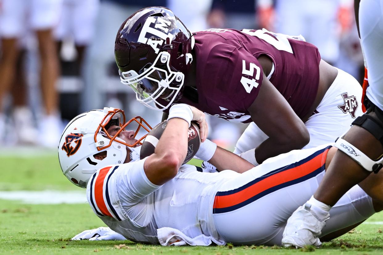 Sep 23, 2023; College Station, Texas, USA; Texas A&M Aggies linebacker Edgerrin Cooper (45) sacks Auburn Tigers quarterback Payton Thorne (1) during the first quarter at Kyle Field. Mandatory Credit: Maria Lysaker-USA TODAY Sports