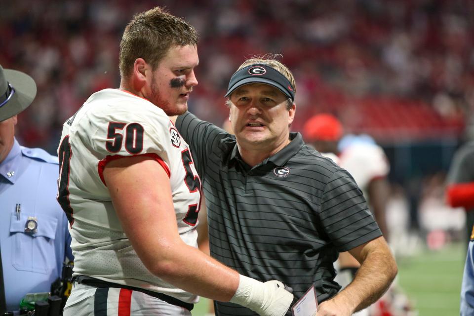 Warren Ericson and head coach Kirby Smart react after a loss to Alabama in the SEC championship.