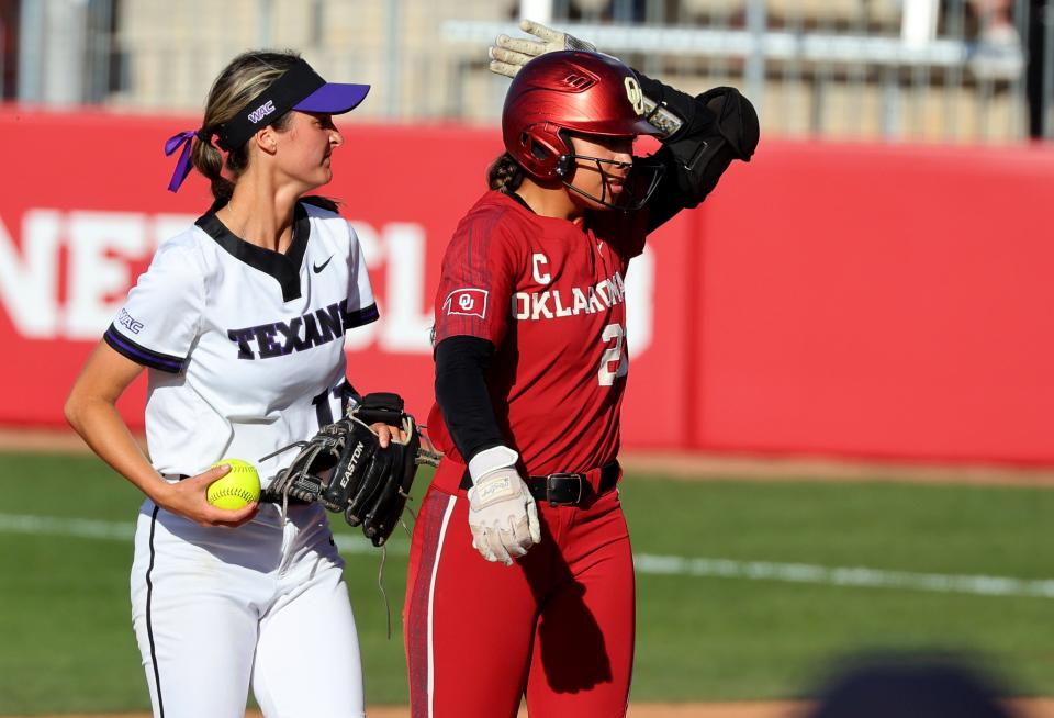 Oklahoma's Tiare Jennings (23) reacts after hitting a double next to Tarleton's Jordan Dickerson during the college softball game between the University of Oklahoma Sooners and Tarleton State University at Love's Filed in Norman, Okla., Tuesday, March 12, 2024.