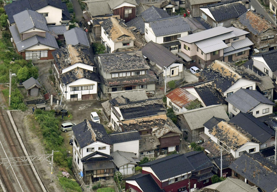 This aerial view shows damaged roof tiles of residential houses in Tsuruoka, Yamagata prefecture, northwestern Japan, Wednesday, June 19, 2019, after an earthquake. The powerful earthquake jolted northwestern Japan late Tuesday, prompting officials to issue a tsunami warning along the coast which was lifted about 2 ½ hours later. Tsuruoka city officials were helping coastal residents evacuate to higher ground as a precaution. (Kyodo News via AP)