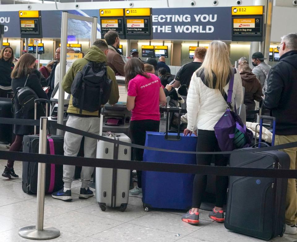 People queuing to check-in at Heathrow Terminal 2 (PA)