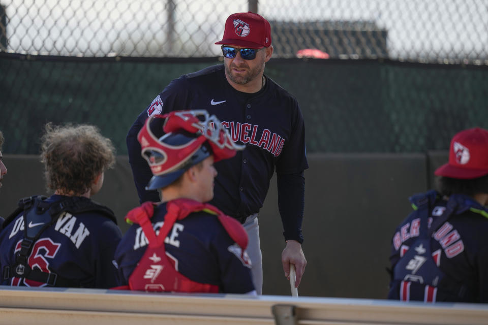 Cleveland Guardians manager Stephen Vogt, top,talks with catchers during spring training baseball workouts in Goodyear, Ariz., Friday, Feb. 16, 2024. (AP Photo/Carolyn Kaster)