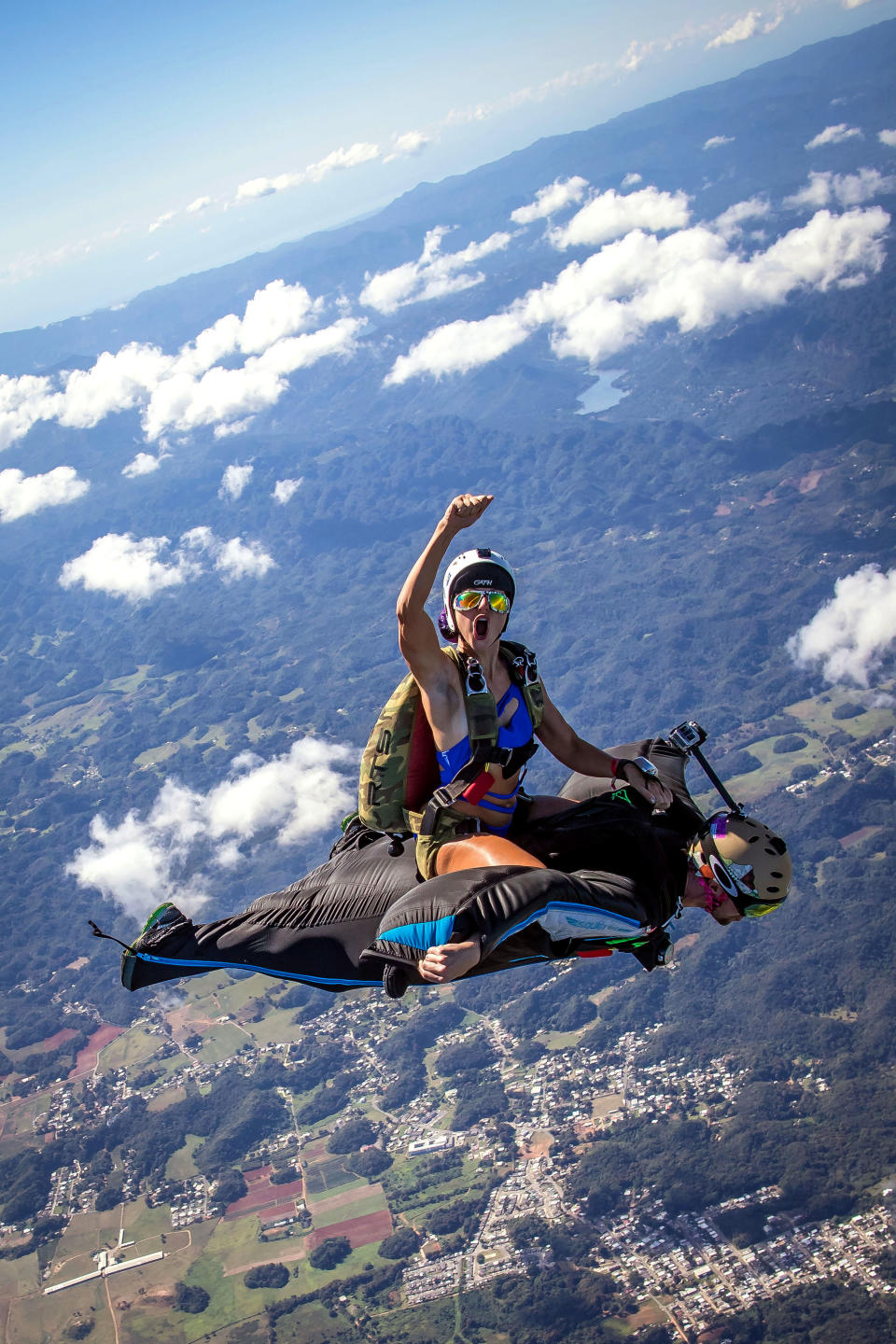 Robyn Young travels on the back of Oliver Miller as they descend during a jump over Arecibo, Puerto Rico. (Photo: Skwrl Productions/Caters News)