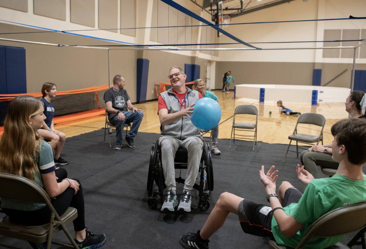 Jason Kolb plays a modified version of Nine Square in which the players are all seated during the middle school youth group at Riverwood Chapel in Kent.