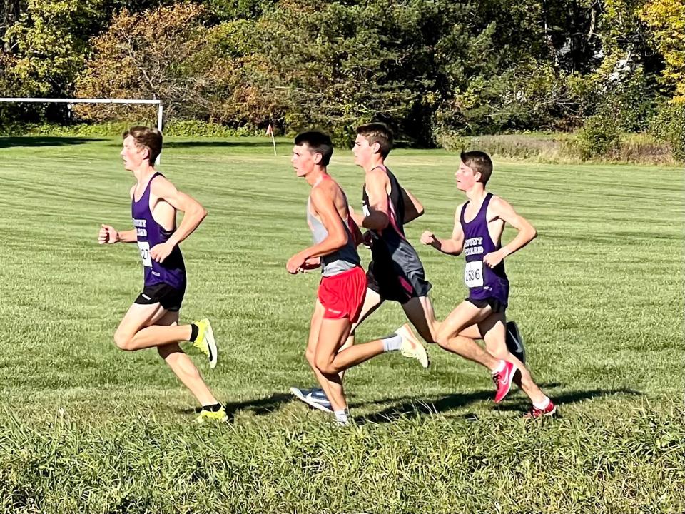 Mount Gilead's Will Baker, left, and Parker Bartlett, right, are part of the lead pack just by the mile marker during Saturday's Marion Harding Cross Country Invitational.