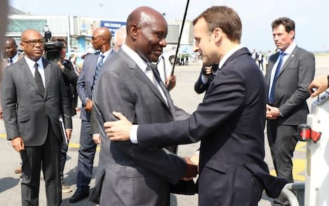 French President Emmanuel Macron (R) is welcomed by Ivorian Vice President Daniel Kablan Duncan (L) at Port Bouet Airport as he arrives to take part in the 5th African Union-European Union Summit in Abidjan, Ivory Coast - Credit:  Anadolu Agency