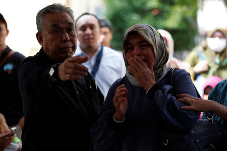 A relative of a passenger on the crashed Lion Air flight JT610 cries as she arrives at Bhayangkara R. Said Sukanto hospital in Jakarta, Indonesia, October 30, 2018. REUTERS/Willy Kurniawan