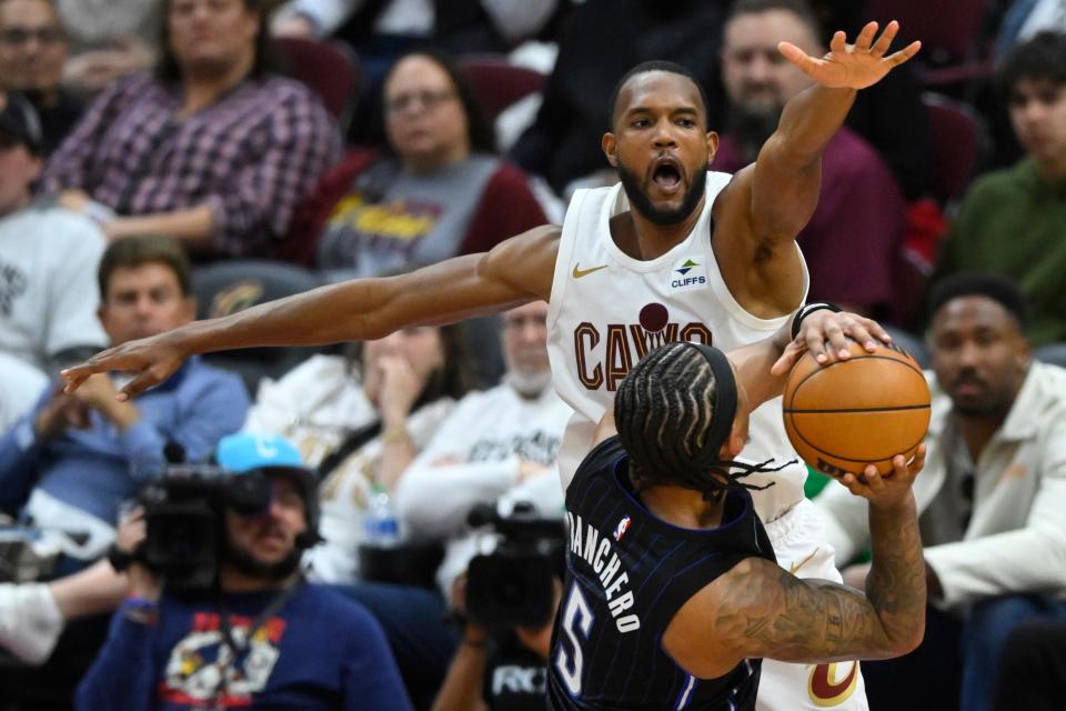 The Cleveland Cavaliers' Evan Mobley defends the Orlando Magic's Paolo Banchero (5) during Game 2 Monday at Rocket Mortgage FieldHouse.