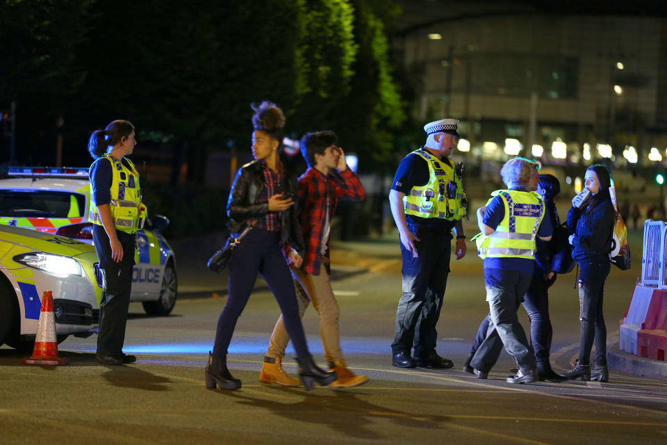 <p>Police and fans close to the Manchester Arena on May 23, 2017 in Manchester, England. There have been reports of explosions at Manchester Arena where Ariana Grande had performed this evening. Greater Manchester Police have have confirmed there are fatalities and warned people to stay away from the area. (Dave Thompson/Getty Images) </p>