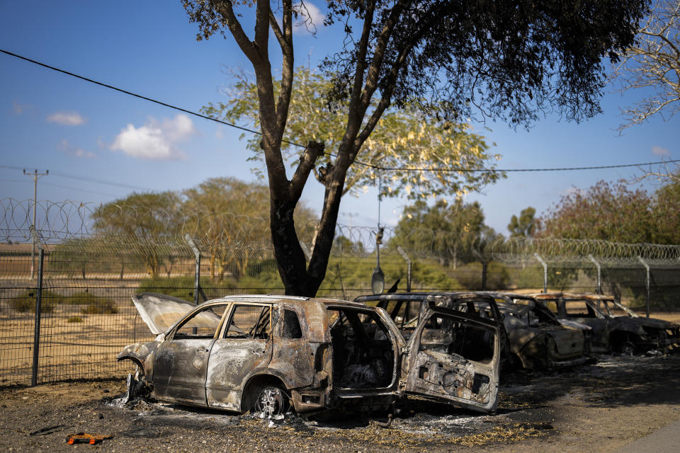 Burned cars next to homes that came under attack during a massive Hamas invasion into Kibbutz Nir Oz, Israel, Thursday, Oct. 19, 2023. Nir Oz is one of more than 20 towns and villages in southern Israel that were ambushed in the sweeping assault by Hamas on Oct. 7. The kibbutz on a low rise overlooking the border fence with Gaza suffered a particularly harsh toll. (AP Photo/Francisco Seco)