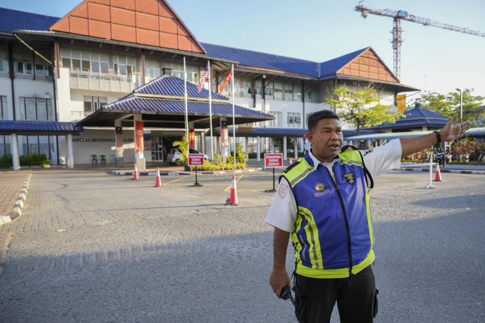 Security personal chase media out from Sultanah Maliha Hospital, where Norway's King Harald believed has been admitted with an infection, on the Malaysian resort island of Langkawi, Malaysia, Thursday, Feb. 29, 2024. Malaysian national news agency Bernama cited unidentified sources as confirming that Europe's oldest monarch was warded at the hospital's Royal Suite. (AP Photo/Vincent Thian)