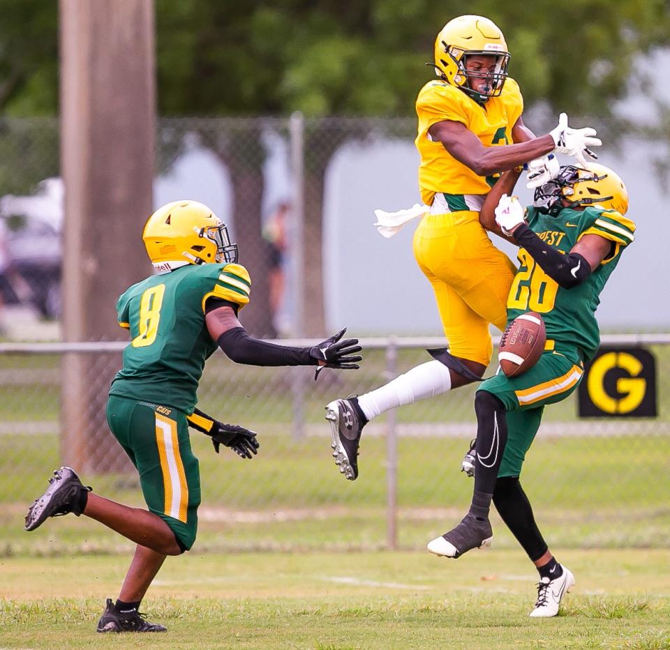 Forest Israel Evans (3) and Forest DeAnthony Sancho (26) battle for a pass reception in the first half intended for (3). Forest held a Spring football scrimmage at Marion County Youth Football League at Jervey Gantt Park in Ocala, FL on Thursday, May 11, 2023.  [Doug Engle/Gainesville Sun]