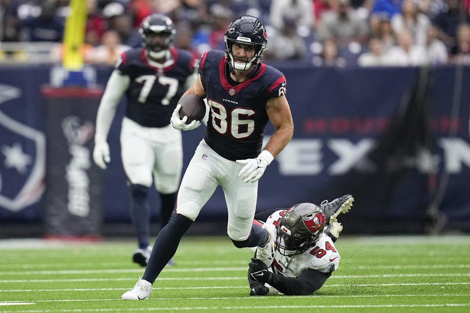 Houston Texans tight end Dalton Schultz (86) avoids a tackle by Tampa Bay Buccaneers linebacker Lavonte David (54) during the second half of an NFL football game, Sunday, Nov. 5, 2023, in Houston. (AP Photo/Eric Gay)