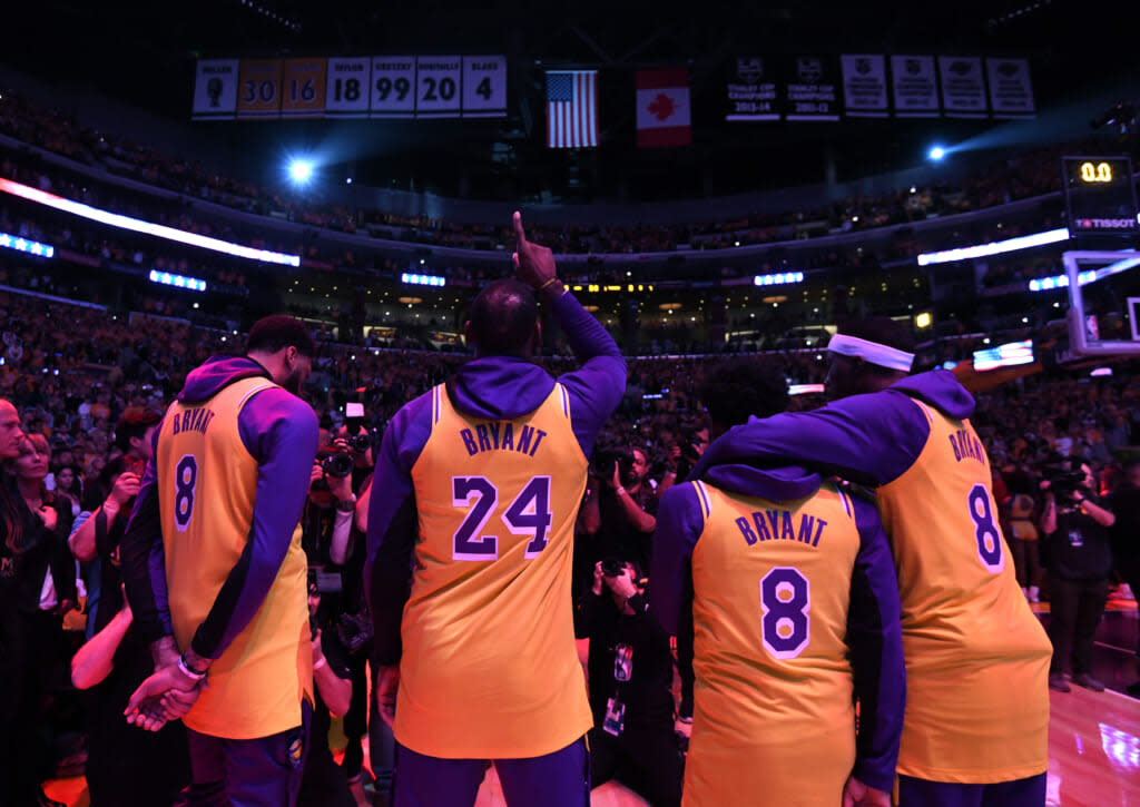 (L-R) Anthony Davis, LeBron James, Quinn Cook and Kentavious Caldwell-Pope of the Los Angeles Lakers reacts at the end of the National Anthem during a ceremony to honor Kobe Bryant before the game against the Portland Trail Blazers at Staples Center on January 31, 2020 in Los Angeles, California. (Photo by Harry How/Getty Images)