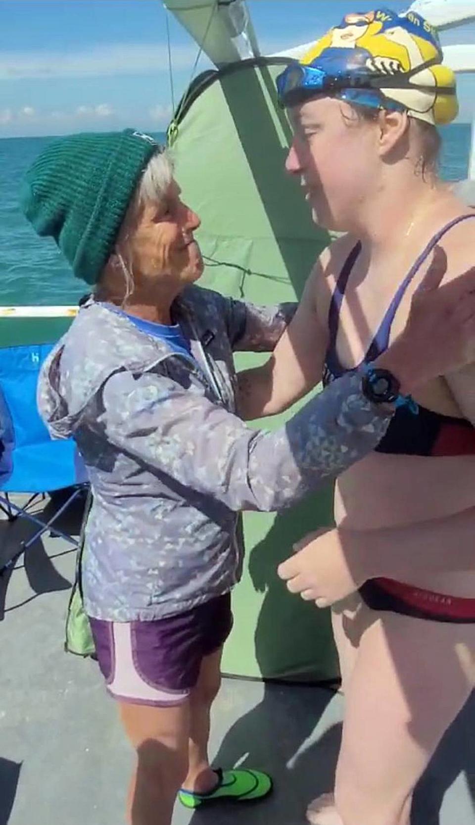 Kay, left, greets Molly on the deck of the support boat after Molly’s successful crossing of the English Channel.