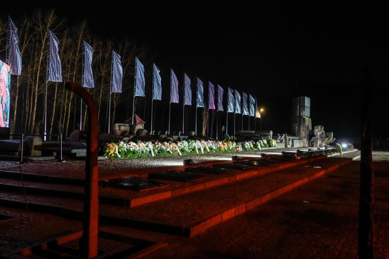 Flowers are placed by the memorial monument at the Birkenau Nazi death camp in Oswiecim, Poland, on Saturday, Jan. 27. Survivors of Nazi death camps marked the 79th anniversary of the liberation of the Auschwitz-Birkenau camp during World War II in a modest ceremony in southern Poland.