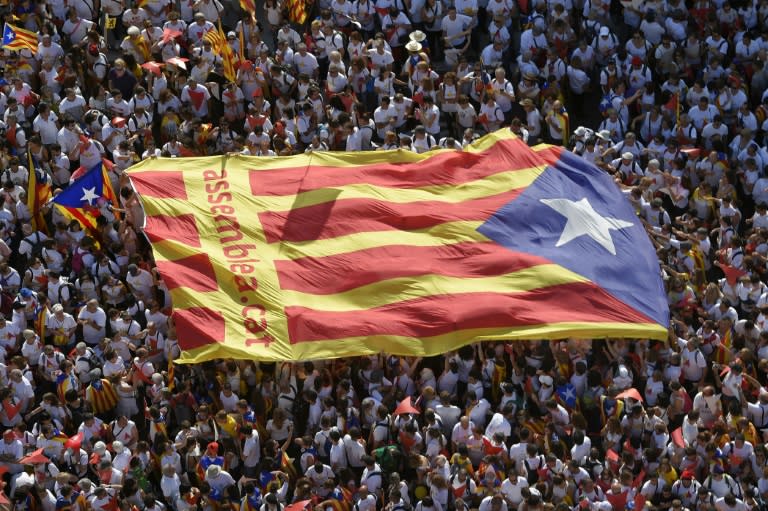 Demonstrators unfold a big "Estelada" (pro independence Catalan flag) during celebrations of Catalonia's National Day (Diada) which recalls the final defeat of local troops by Spanish king Philip V's forces in 1714, in Barcelona on September 11, 2015