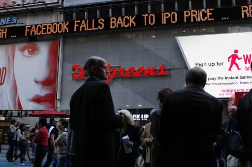 The Times Square news ticker displays a headline on the Facebook stock price on May 18. The suits alleged that Facebook, and Morgan Stanley, Goldman Sachs and other big banks withheld from smaller investors crucial forecasts that pointed to weaker growth for Facebook, while sharing the information with big institutional clients