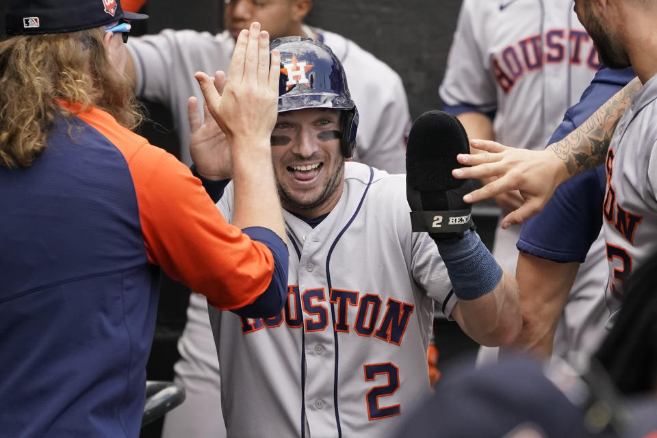 Houston Astros' Alex Bregman (2) celebrates in the dugout after scoring on a Kyle Tucker's single off Chicago White Sox starting pitcher Lucas Giolito during the third inning of a baseball game Thursday, Aug. 18, 2022, in Chicago. (AP Photo/Charles Rex Arbogast)