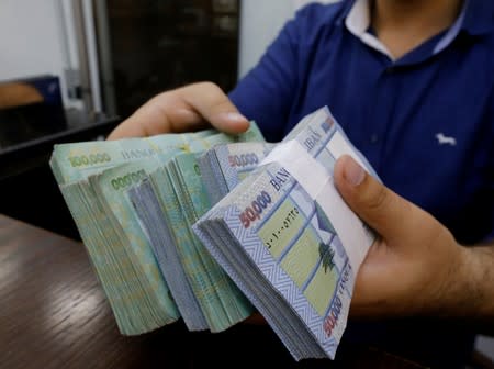 FILE PHOTO: A money exchange vendor displays Lebanese pound banknotes at his shop in Beirut