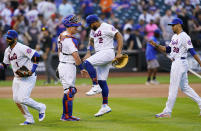 New York Mets catcher James McCann (33) slaps hands with left fielder Dominic Smith (2) as third baseman Jonathan Villar (1) and relief pitcher Edwin Diaz (39) leave the field after defeating the Atlanta Braves in the first baseball game of a doubleheader, Monday, June 21, 2021, in New York. (AP Photo/Kathy Willens)