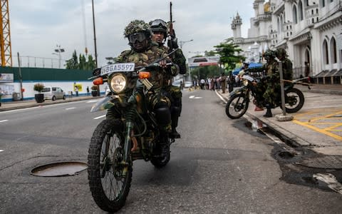 Police presence is high on the streets of Colombo amid fears of further attacks - Credit: Carl Court/Getty Images