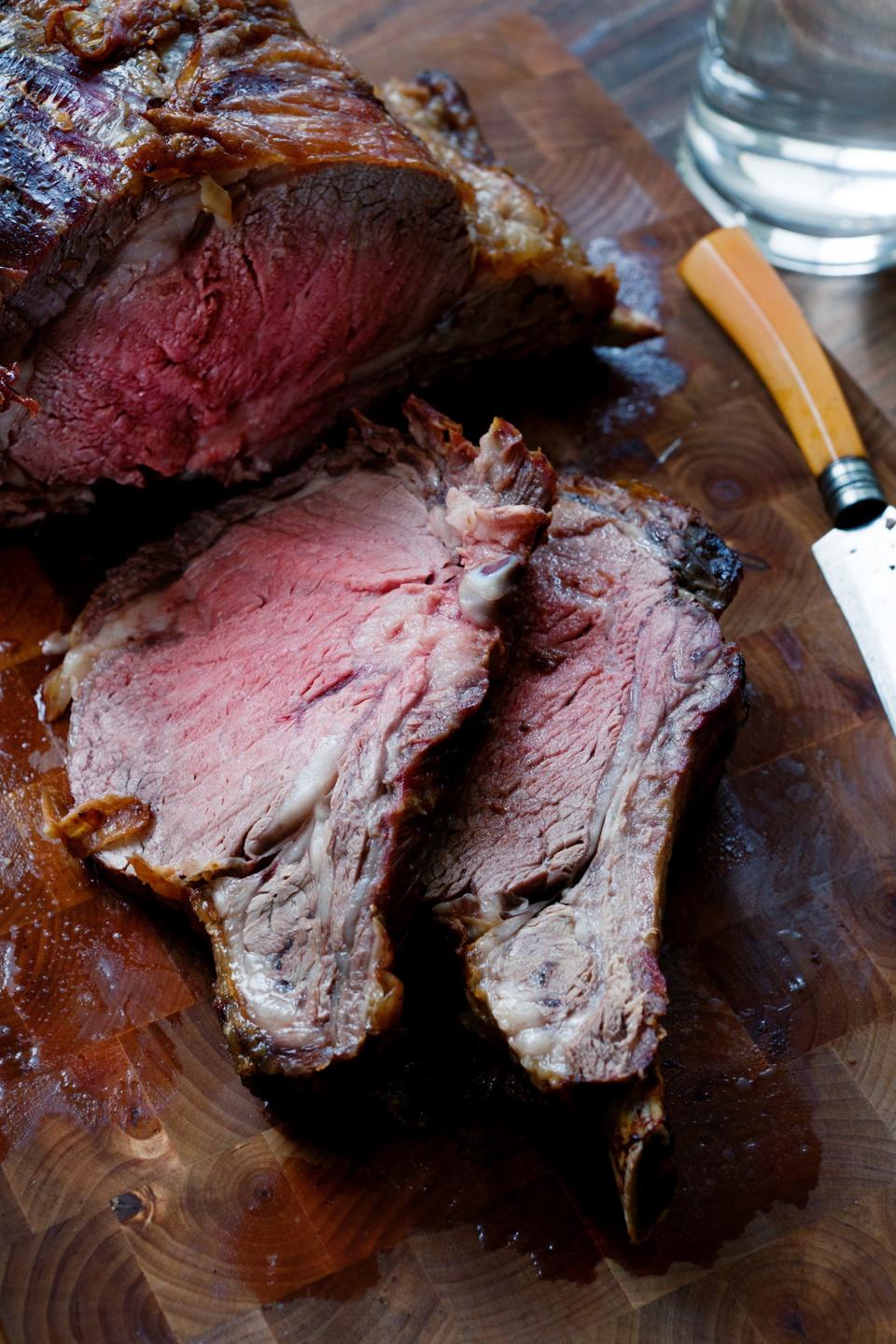 Standing rib roast of beef is cooked by Erica Marcus in her apartment in Brooklyn, New York, December 14, 2010. Here, slices lie on a cutting board. (Michael Gross/Newsday/MCT)