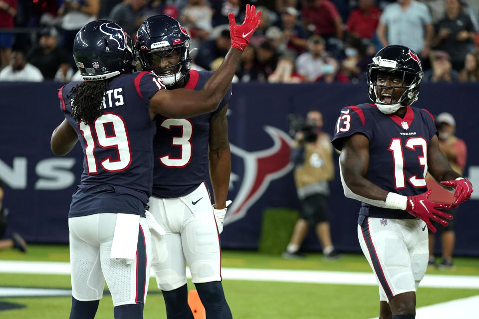 Houston Texans' Anthony Miller (3) celebrates with Andre Roberts (19) and Brandin Cooks (13) after making a touchdown catch against the Carolina Panthers during the first half of an NFL football game Thursday, Sept. 23, 2021, in Houston. (AP Photo/Eric Christian Smith)