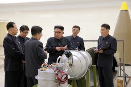 FILE PHOTO: North Korean leader Kim Jong Un provides guidance with Ri Hong Sop (3rd L) and Hong Sung Mu (L) on a nuclear weapons program in this undated photo released by North Korea's Korean Central News Agency (KCNA) in Pyongyang September 3, 2017.  KCNA via REUTERS/File Photo