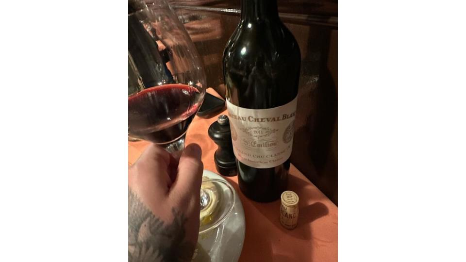 Brooklyn beckhams hand with wine bottle