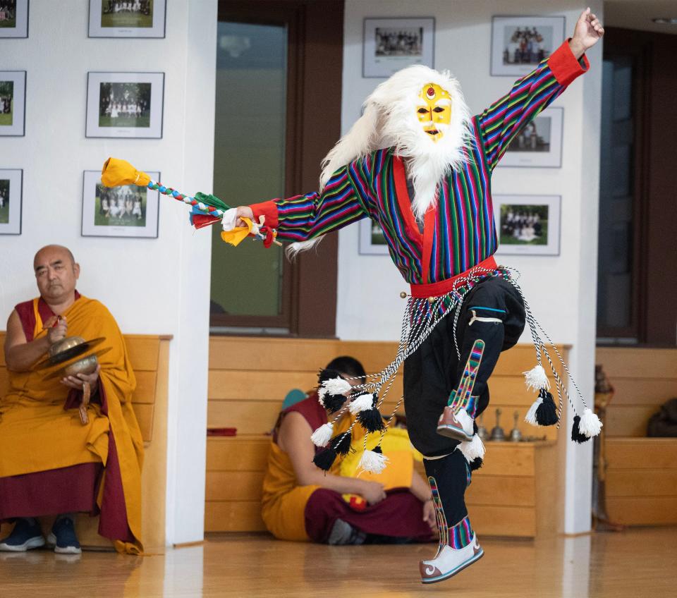 A Tibetan monk does "The Good Luck Dance" during a visit to Canton Country Day School.