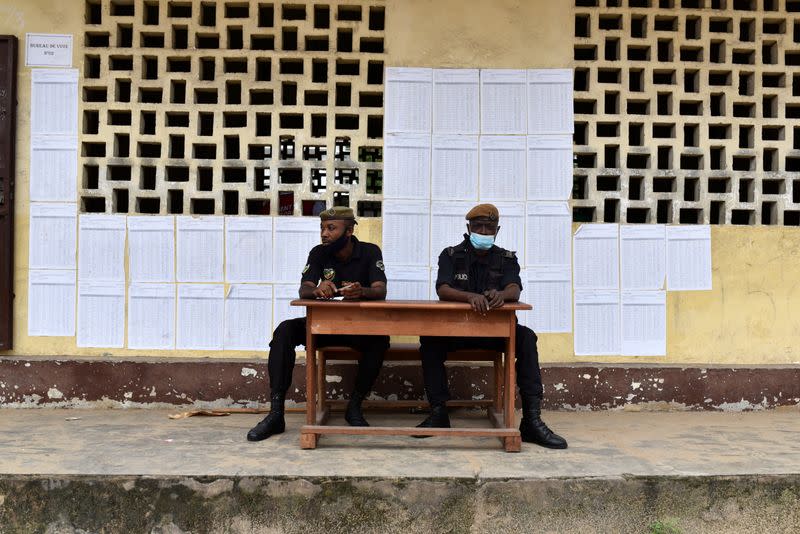 Security forces sit outside a polling station during the presidential election in Brazzaville