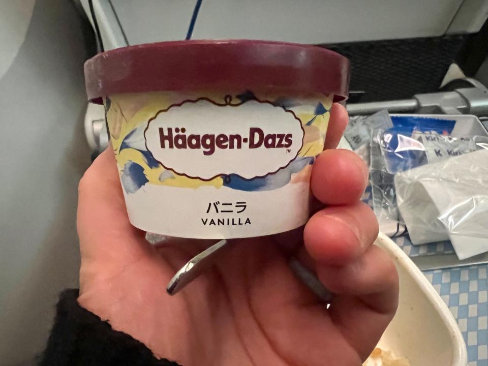 The author holding the Haagen-Dazs vanilla ice cream container.