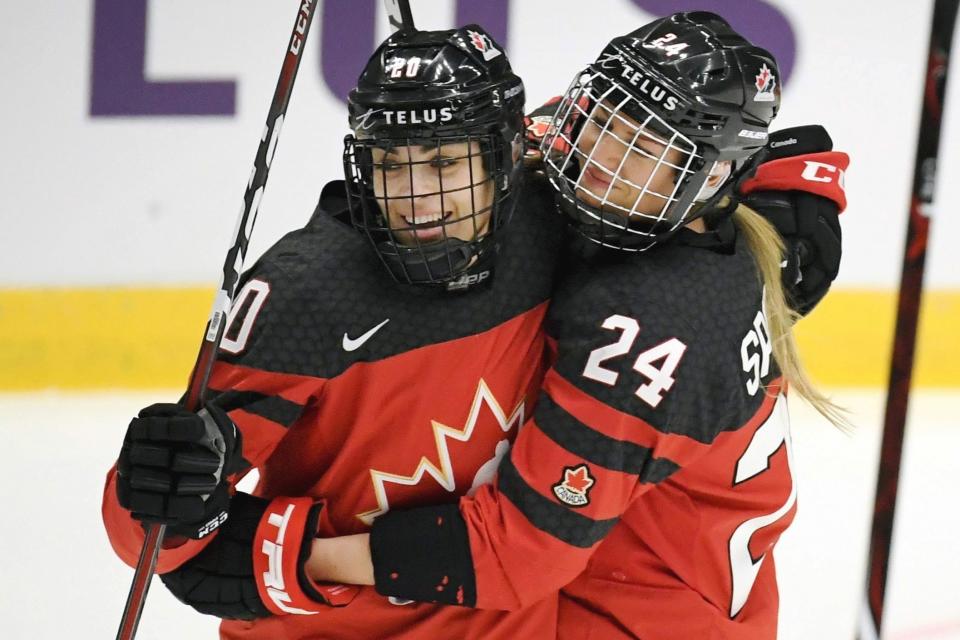 FILE - In this April 4, 2019, file photo, Canada's Sarah Nurse, left and Natalie Spooner celebrate Spooner's goal against Switzerland during a Hockey Women's World Championships preliminary match in Espoo, Finland. Canada and the United States teammates renew their fierce hockey rivalry on Saturday, Dec. 14, in Hartford, Conn., with players hoping the first in a series of five games will help kindle the public's interest in their sport and their fight for better professional opportunities. (Antti Aimo-Koivisto/Lehtikuva via AP, File)