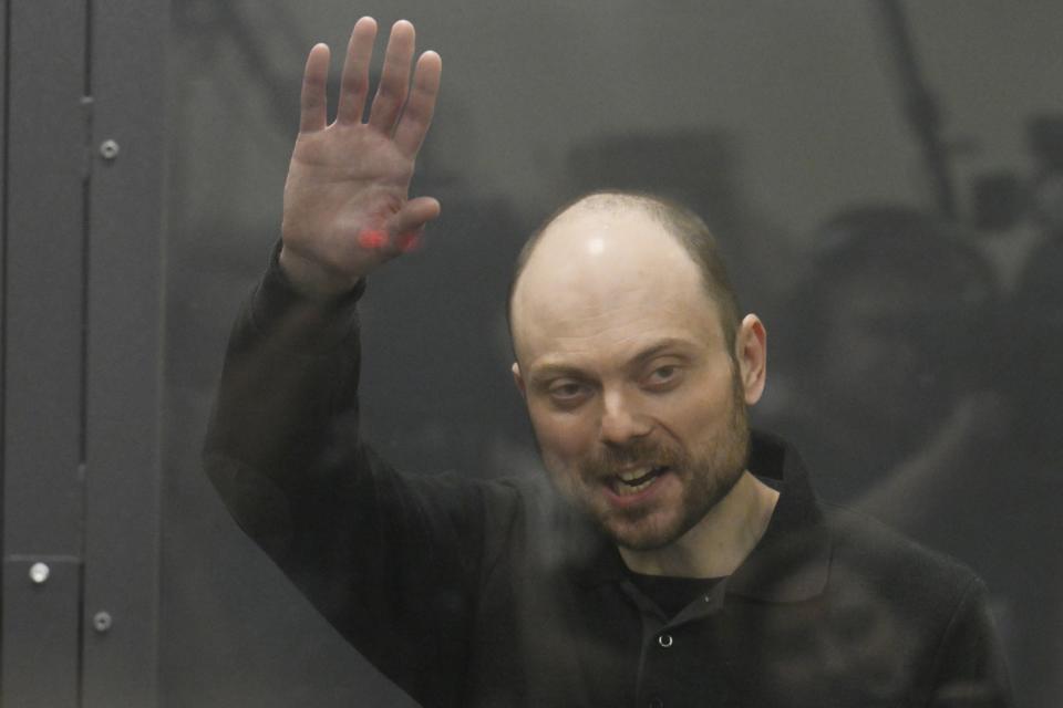 FILE - Russian opposition activist Vladimir Kara-Murza waves from a glass cage in a courtroom in Moscow, on July 31, 2023. Kara-Murza has been sentenced to 25 years in prison on charges of treason for publicly denouncing Russia's operation in Ukraine. Russian authorities have adopted a slew of laws restricting fundamental human rights, including freedom of speech and assembly, as well as the rights of minorities and religious groups. (AP Photo, File)