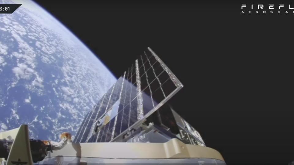 view of a spacecraft's solar panel against the curve of earth and the blackness of space.