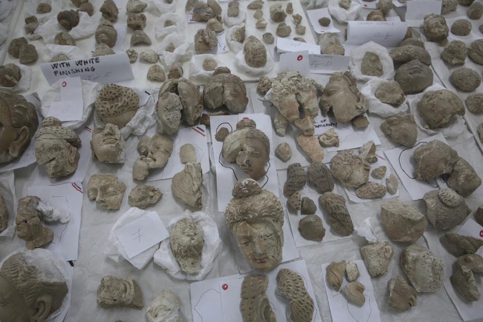 In this Saturday, Aug. 17, 2019 photo, small statues damaged by the Taliban are laid out on a table for restoration at the National Museum of Afghanistan, in Kabul, Afghanistan. Taliban fighters armed with hammers 18 years ago shattered ancient Buddha figurines because they were judged to be against Islam. (AP Photo/Rafiq Maqbool)