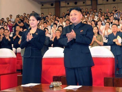 North Korean leader Kim Jong Un and a young woman believed to be Ri Sol-Ju enjoy a concert in Pyongyang on July 6. Kim is married, state media has confirmed, ending weeks of speculation about the identity of a stylish young woman seen accompanying him at official events