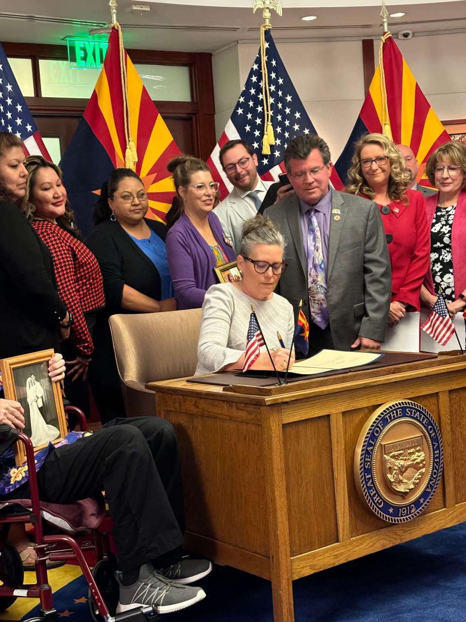 Gov. Katie Hobbs signs a long-term care reform bill into law at the Arizona state Capitol in Phoenix on April 8, 2024.