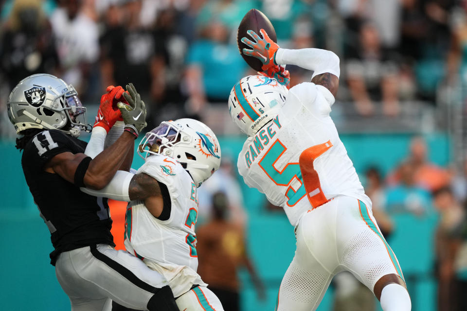 Miami Dolphins cornerback Jalen Ramsey (5) intercepts a pass. Mandatory Credit: Jasen Vinlove-USA TODAY Sports