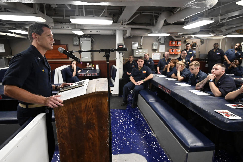 In this image provided by the U.S. Navy, Capt. Edward Crossman, assigned to the guided-missile cruiser USS San Jacinto (CG 56), speaks to the sailors aboard the ship during a talent show in the Arabian Sea May 15, 2020. When coronavirus made U.S. Navy ship stops in foreign countries too risky, the USS Dwight D Eisenhower and the USS San Jacinto were ordered to keep moving, and avoid all port visits. More than five months after they set sail, they have broken a record they never planned to achieve. As they steamed through the North Arabian Sea on June 25, they notched their 161st consecutive day at sea, breaking the previous Navy record of 160 days. (Mass Communication Specialist 2nd Class Maxwell Anderson/U.S. navy via AP)