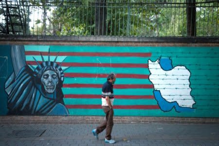 FILE PHOTO: A man walks past an anti-U.S. mural in Tehran, Iran October 13, 2017. Nazanin Tabatabaee Yazdi/TIMA/File Photo via REUTERS