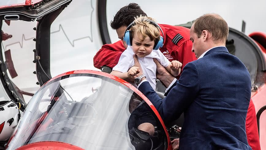 Prince William puts his son in a plane. Source: Getty