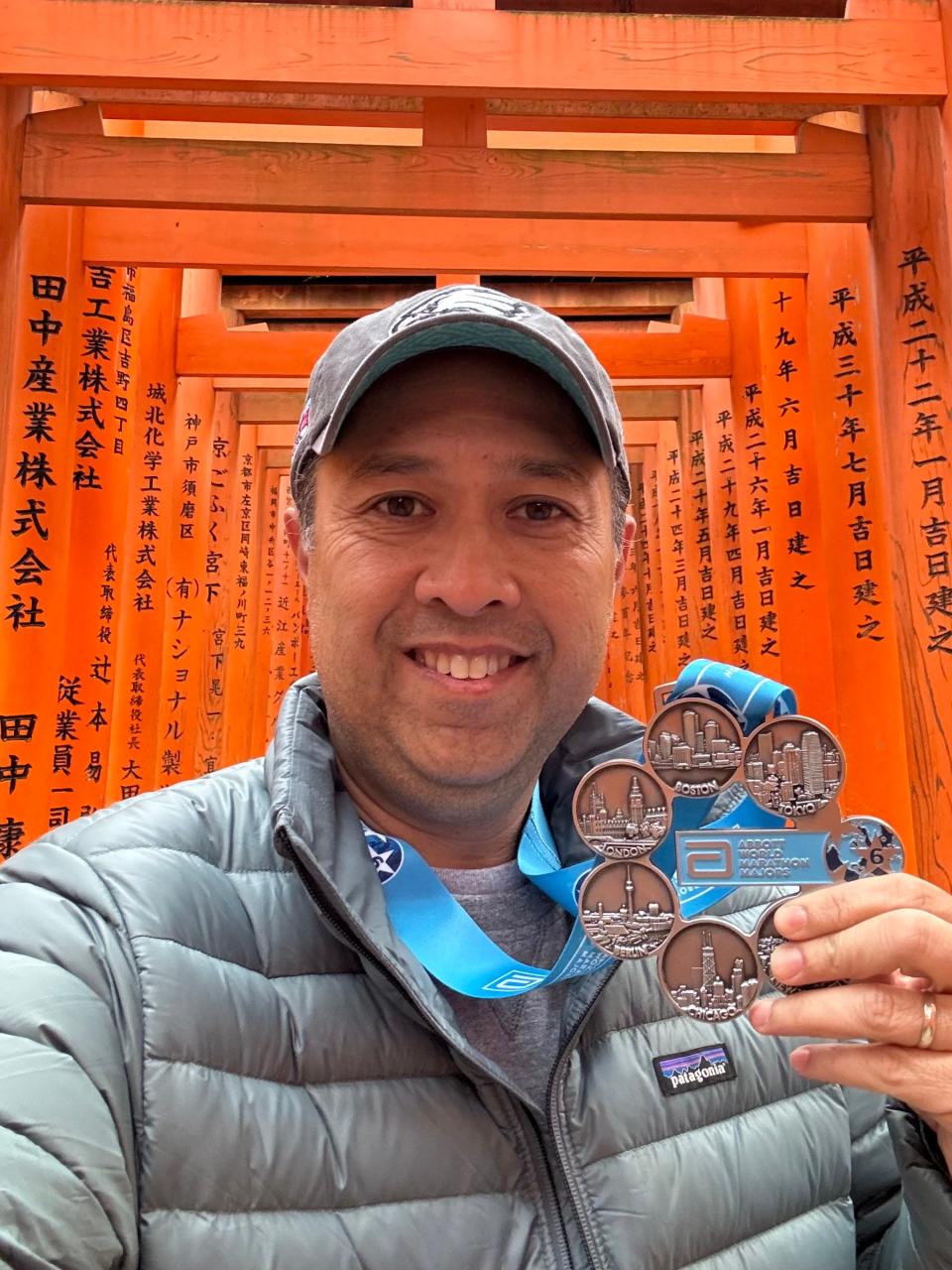 Apollo Lirio holds his Abbott World Marathon Majors Six Star Medal.