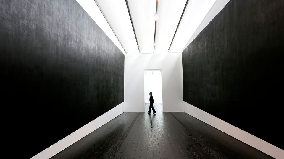 A museum employee walks through Richard Serra's "Two Corner Cut: High Low" at the Menil Collection in Houston, Texas. - Elizabeth Conley/AP